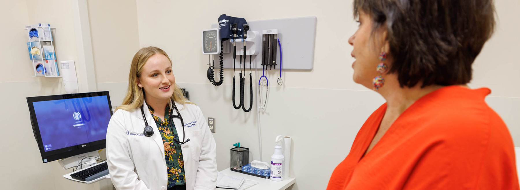 residents speaking to patient in exam room